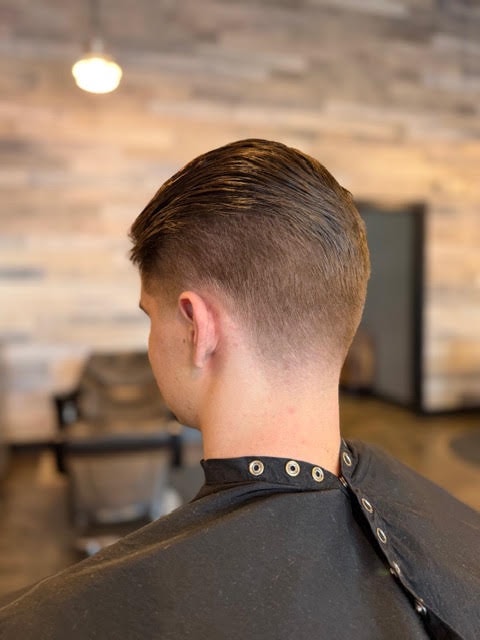 Man showing a fresh tapered haircut in the barbershop