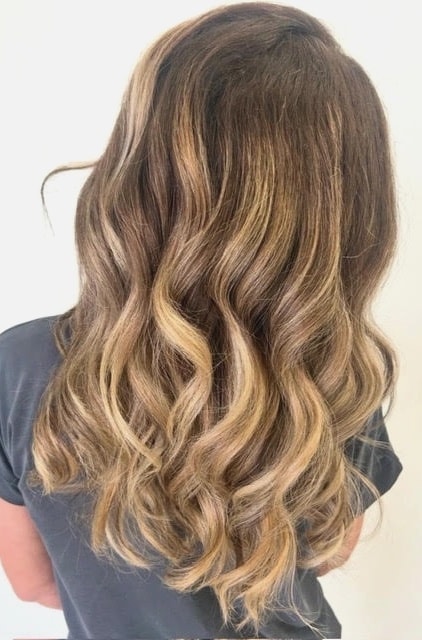 Long wavy hair with balayage highlights blending from brown to blonde
